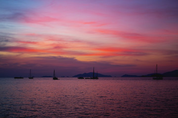 Fototapeta na wymiar Silhouette Longtail boat with coastal fishing village,Beautiful scenery view in sunset twilight time.