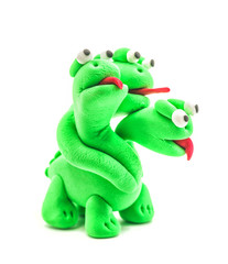 green hand made modeling clay dragon with three heads isolated on white