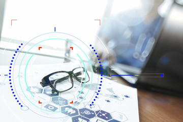 Doctor working with  laptop computer and eye glass in medical workspace office and medical network media diagram as concept