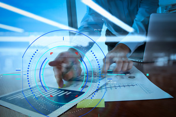 double exposure of businessman hand working with business documents on office table with laptop computer with social media diagram