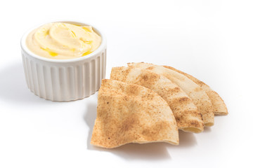 Hummus in a bowl and arabic bread