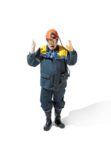The studio shot of senior bearded male miner standing at the camera on a white background.