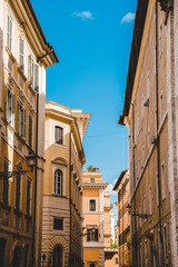 Fototapeta na wymiar ancient buildings on street of Rome on sunny day, Italy