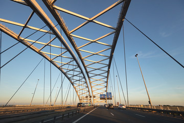 Driving on highway under suspension bridge