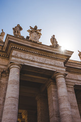 bottom view of statues and arch at St Peters Square in Vatican, Italy
