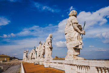 Fototapeta na wymiar statues on top of St Peters Basilica, Vatican city, Italy