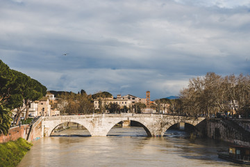 Fototapeta premium bridge over tiber river on cloudy day, Rome, Italy