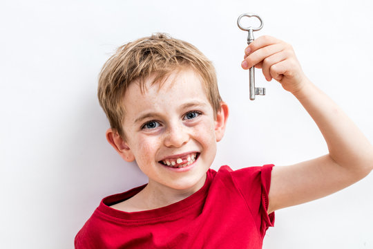 Giggling Toothless Child Holding Key For Concept Of Fun Idea