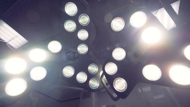 Surgical lights move above an operating table. 4K.