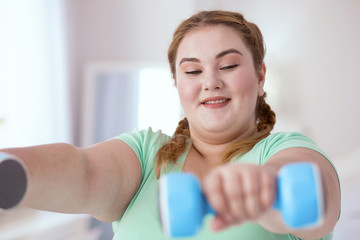 Turquoise shirt. Young red-head woman wearing turquoise shirt while working out