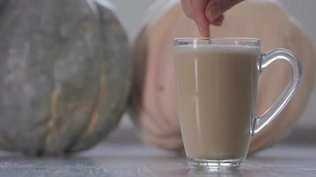 Pumpkin latte in a glass cup
