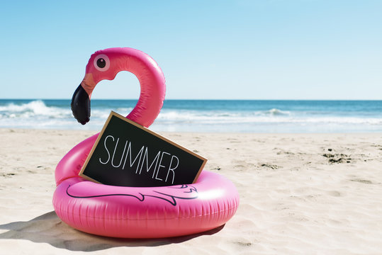 flamingo swim ring on the beach and text summer