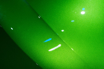 Abstract of green car front hood surface with light reflection