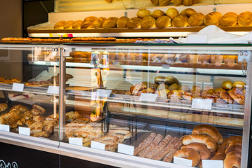 glass shelves with fresh bread and buns in the bakery