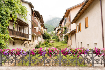  fence decorated with flower vases in the Levico Terme , a village in the Italian Alps