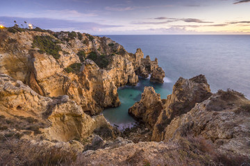 Fototapeta na wymiar Sunset over stunning cliffs in Ponta da Piedade, Lagos, Algarve, Portugal