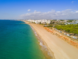 Wide sandy beach in touristic Quarteira and Vilamoura, Algarve, Portugal