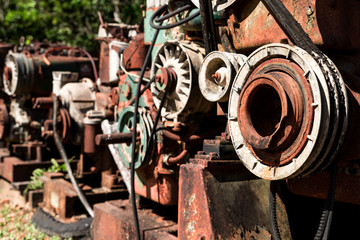 Close up view of Pulley and engine is old and deteriorate rusty thick. Place it outdoors