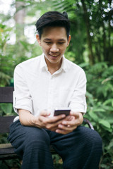 Fototapeta premium Thai man with smartphone