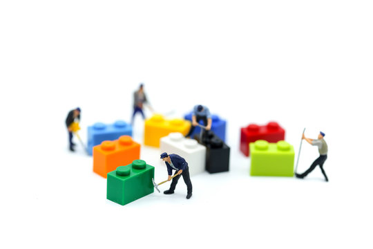 Miniature people : worker with colorful Kids toys.