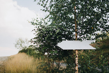 in the area of the wedding ceremony with a view of the mountains hanging pointer in the form of a white arrow