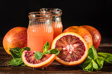 Jars of fresh blood orange juice, selective focus