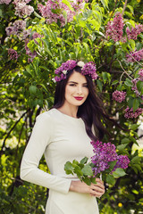 Attractive Brunette Woman Outdoors on Floral Spring Background