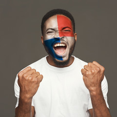 Young man with flag painted on his face