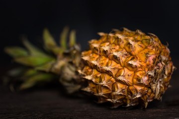Pineapple on a dark wooden background