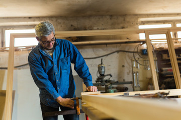 Mid-age carpenter in his workshop