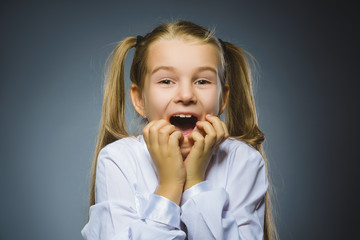 Happy girl. Closeup Portrait handsome child smiling isolated on grey