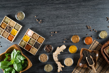 Selection of spices, herbs and greens. Grey stone background., copy space.
