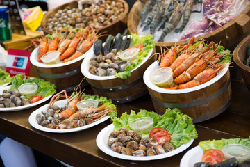 Grilled shrimps, Squid, shells seafood on the table in market of Bangkok Thailand 