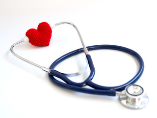 red heart using stethoscope on the white background (Isolated background).  Concept of love and caring patient by the heart. Copy space for the text and contents