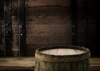 Excellent red wine bottles, wineglass, barrel and corkscrew on a rustic wooden table: traditional winemaking and wine tasting concept