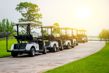Golf carts park on road in golf course