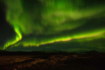 A wonderful night with Kp 5 . Northern lights mountain in Iceland.