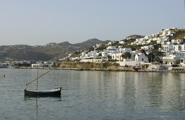 Little Greek Fishing Village with cute white houses on a calm day