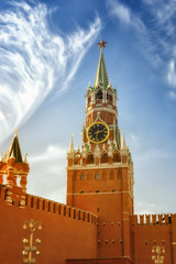 Fototapeta premium The famous Spasskaya tower of Moscow Kremlin, Russia. Spasskaya tower on the blue sky background in the sunlight.