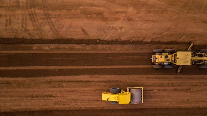 Aerial top view Tractor and Earthmoving at work. - obrazy, fototapety, plakaty