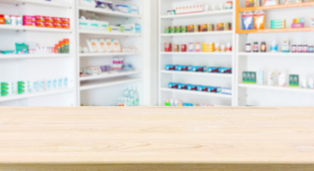 Pharmacy drugstore counter table with blur abstract backbround with medicine and healthcare product on shelves