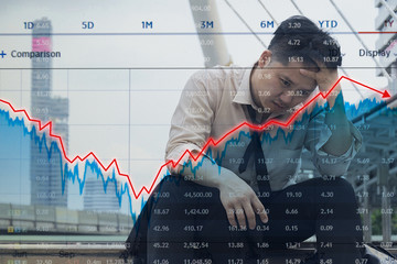 Businessman grabs the head concept with business chart on scoreboard.