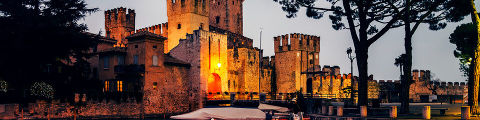 Illuminated Scaliger Castle in Sirmione, Italy - obrazy, fototapety, plakaty