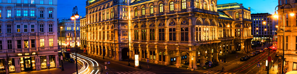 Fototapeta premium View of State Opera in Vienna, Austria during the night. Bright blue sky