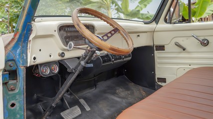 View of steering wheel inside of old-fashioned vintage car.
