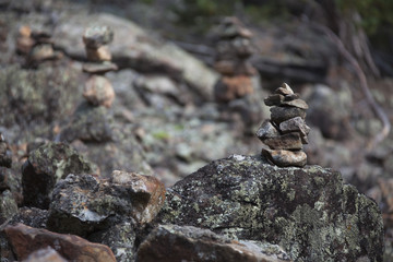 man-made pyramids of rocks in forest