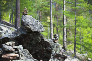 man-made pyramids of rocks in forest