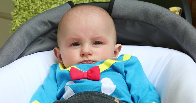 Portrait of a Cute Baby Boy Five Month Old Wearing Funny Costume in His Pram. Close Up View - DCi 4K Resolution