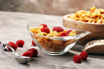 Bowl of Cornflakes and Raspberries for a healthy breakfast concept