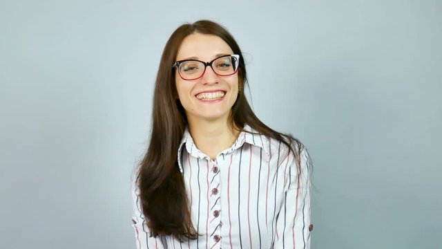 Laughing Happy Smart Female Student Wearing Optical Eyeglasses Posing in Studio on Grey Background.